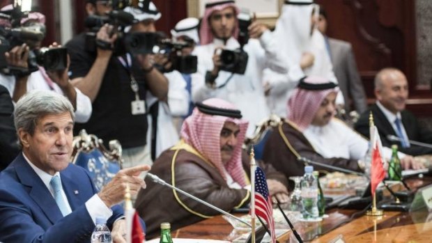 US Secretary of State John Kerry, left, talks with attendees before a meeting of the Gulf Arab region at King Abdulaziz International Airport in Jiddah, Saudi Arabia.