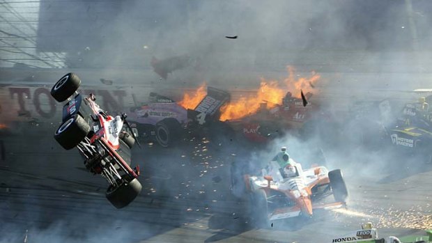 Will Power's car is airborne after it was caught up in the crash that killed Dan Wheldon.