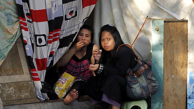 Filipino illegal workers eat in their makeshift tent set up on a main street outside their consulate in the coastal seaport city of Jeddah.