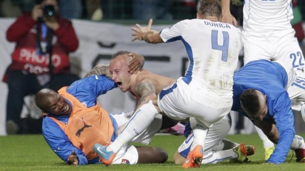 Slovakia's Miroslav Stoch, second left, celebrates with teammates after scoring his side's winning goal.