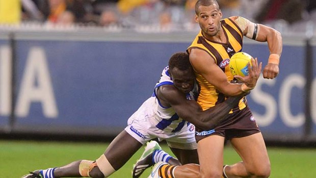 Stopped: Hawthorn’s Josh Gibson tackled by North’s Majak Daw.