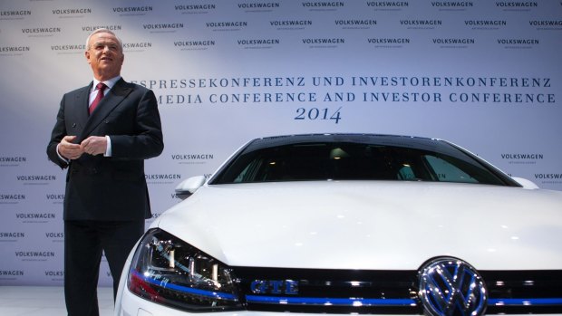 Former VW chief Martin Winterkorn, who stepped down amid the emissions test rigging scandal, beside a Volkswagen Golf GTE electric automobile. The company now plans to push electric cars.