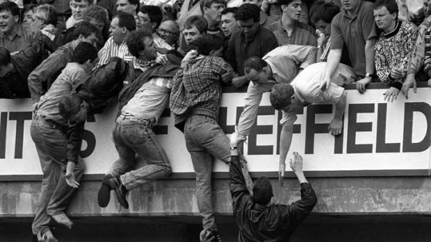 Liverpool fans trying to escape severe overcrowding during the severe crushing at Hillsborough stadium in 1989.