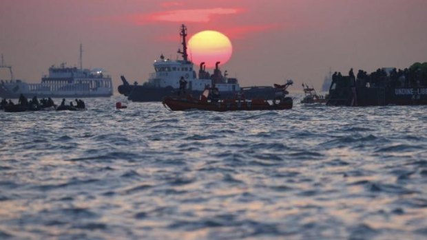 South Korean rescue workers operate during sunset near the site where the capsized ferry Sewol sank.
