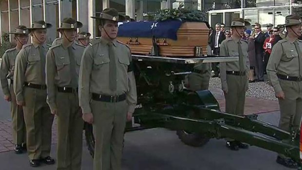 Lance Corporal Andrew Jones's coffin is escorted out of the service.