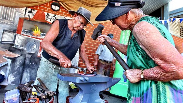 Not finished yet: Ray Lincoln, assisted by his wife, Heather, is giving blacksmith demonstrations at the Royal Easter Show.