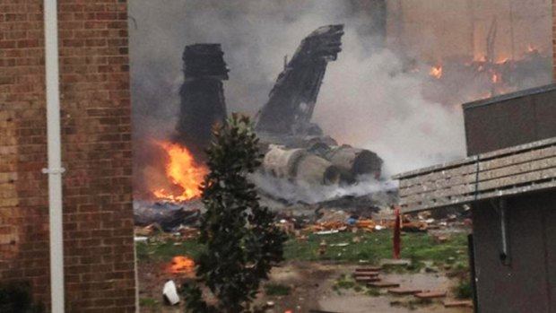 The smouldering ruins of a fighter jet that crashed into Devin Smith's building.