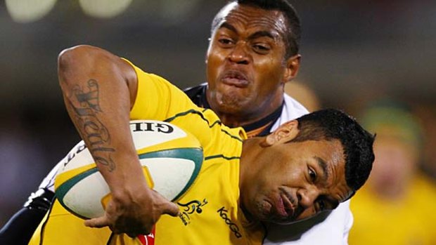 Kurtley Beale of the Wallabies is tackled.