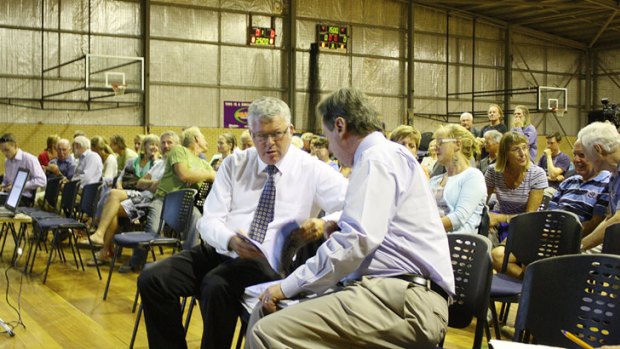 Not well received... Emergency Services Minister Troy Buswell and Margaret River bushfire inquiry report author Mick Keelty in deep discussion before a community meeting on the report and the government’s response at Margaret River last night.