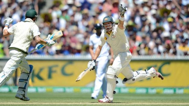 Shane Watson celebrates hitting the winning runs with captain Michael Clarke.