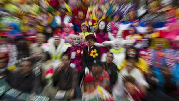 A group of clowns smile during a family photo for the Latin American Clown Convention in Mexico City.