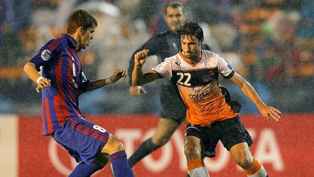 The Roar's Thomas Broich controls the ball against Aria Jasuru Hasegawa of FC Tokyo during their AFC Asian Champions League Group F match in Japan.