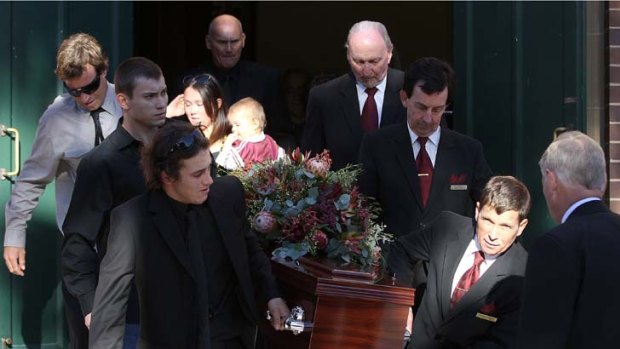 Pall-bearers carry the casket at the funeral service for former Rugby League player and commentator Rex Mossop at St Matthew's Anglican Church today.