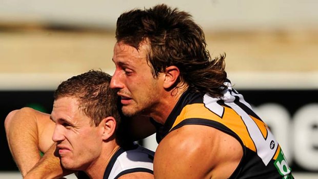 Squeeze: Richmond's Ivan Maric tackles Geelong's Joel Selwood.