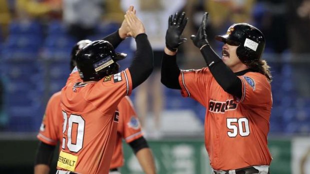 Jack Murphy, right, of the Canberra Cavalry celebrates with team mate Jeremy Barnes after hitting a grand slam.