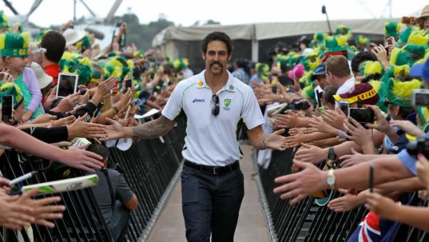 Mitchell Johnson walks to the stage to the outstretched hands of fans.