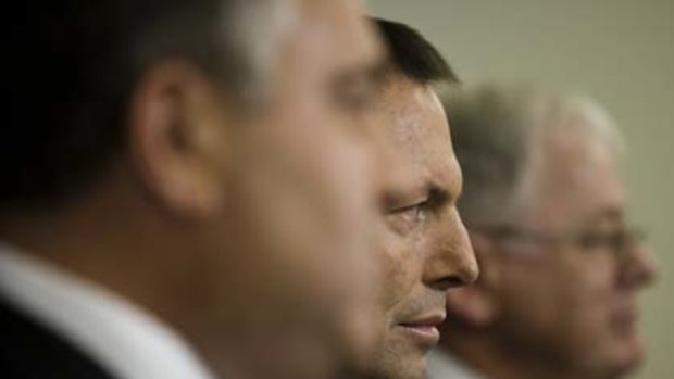 Opposition Leader Tony Abbott, flanked by his Treasury spokesman, Joe Hockey, and finance spokesman, Andrew Robb.