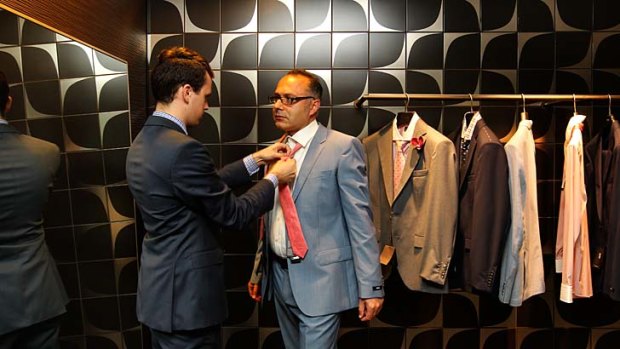 Fitting: Alex Kambos is measured for a Hugo Boss suit at DJs.