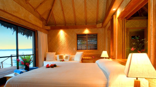 The interior of an over-water bungalow at Aitutaki Lagoon Resort & Spa.