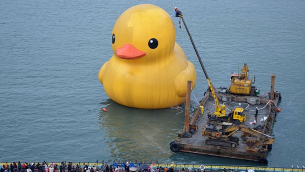 Workers clean the giant rubber duck in Keelung, Taiwan, last month.