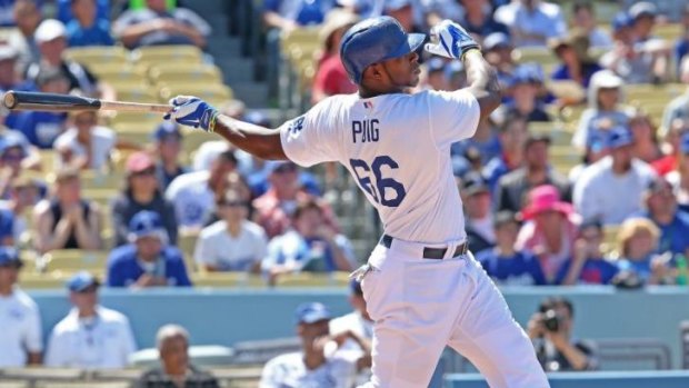 Power-hitter: Puig hits a three-run homer for the Dodgers on Sunday.