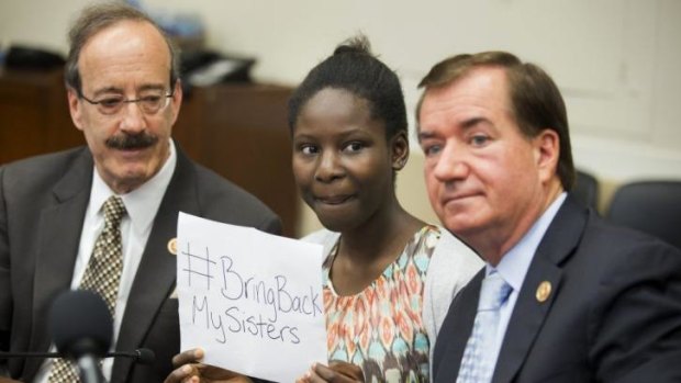 Deborah Peter, flanked by US congressmen. Peter is a sole survivor of a 2011 Boko Haram attack on her household.