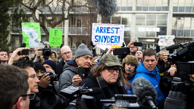Filmmaker Michael Moore, who was born in Flint,  attends a rally outside City Hall, accusing Michigan Governor Rick Snyder of poisoning the city's water.