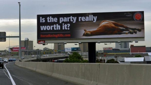  In question: The billboard featuring a photo of a dead racehorse.
