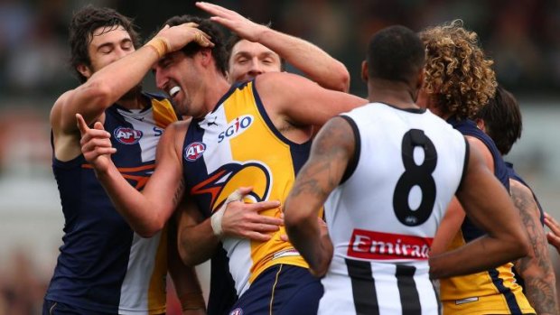 Teammates congratulate Dean Cox after he scored in Sunday’s big win against Collingwood.