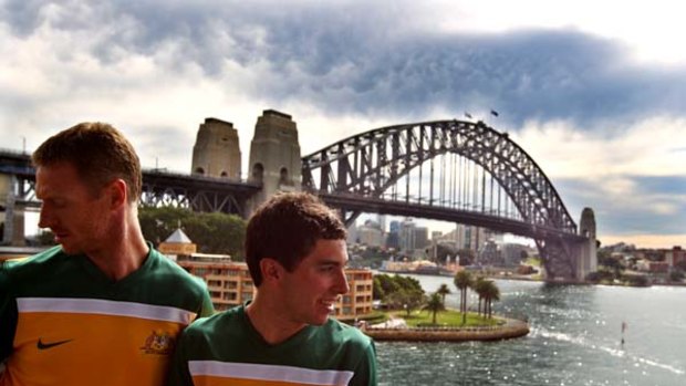 Socceroos Craig Moore and Tommy Oar on Sydney Harbour with the new World Cup strip for South Africa.