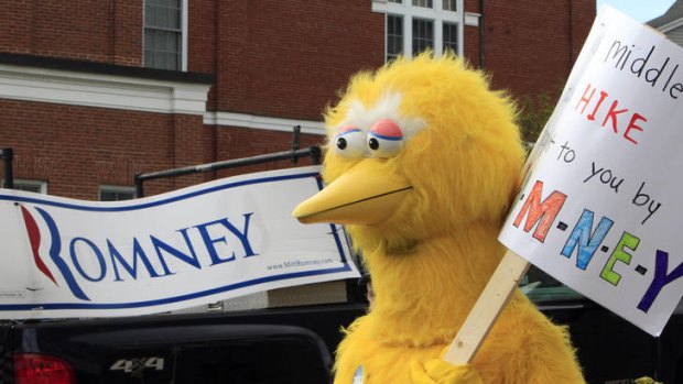 Yellow fever ... a person dressed as Big Bird demonstrates outside Mitt Romney's headquarters in Massachusetts.