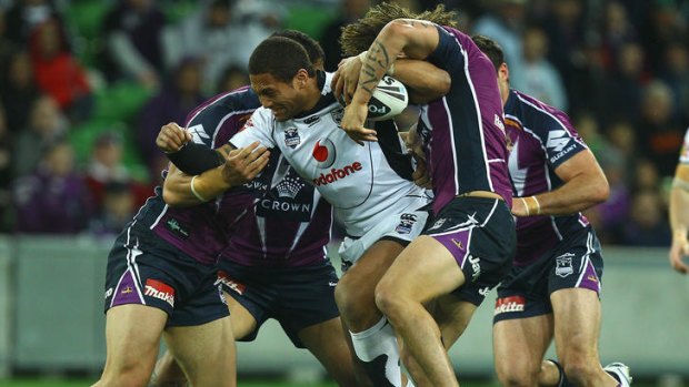 Committed ... Manu Vatuvei of the Warriors is tackled during the NRL second preliminary final match between the Storm and the Warriors.