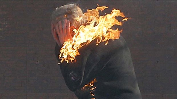 Many victims ... An anti-government protester is engulfed in flames during clashes with riot police.