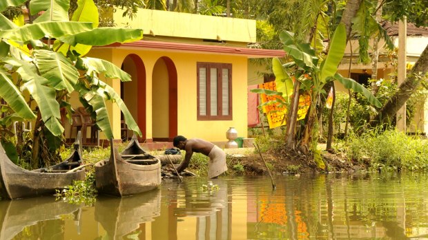 Colourful, boxy houses typical of the Kerala backwaters .