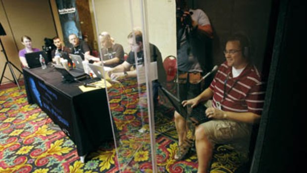 Robert Baldi, right, makes calls to a company attempting to extract sensitive information during a social engineering exercise at the DefCon hacker conference in Las Vegas.