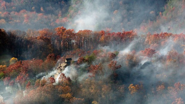 Smoke surrounds a home near Gatlinburg, Tennessee. 