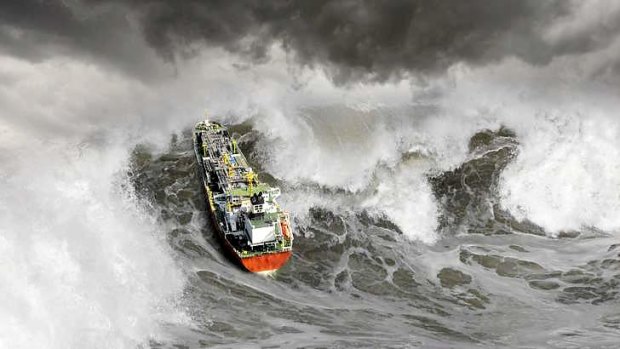 An oil tanker heads into a monster wave.