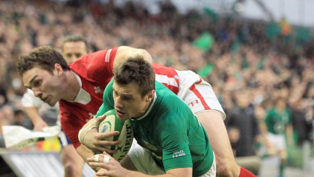 Try time ... Ireland's Tommy Bowe scores a try  despite the tackle by George North.