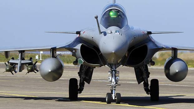 A Rafale jet fighter lands in Corsica after a mission to Libya.