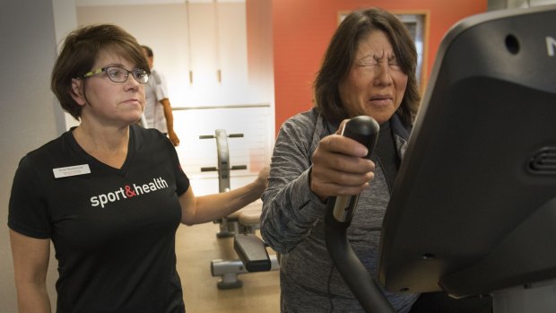 Toni Badinger, a personal trainer, works with client Cynthia Decker (right).
