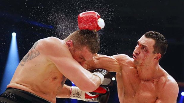 Ukrainian WBA, WBO, IBO and IBF heavyweight boxing world champion Vladimir Klitschko lands a blow on Polish challenger Mariusz Wach during their title bout in Hamburg on November 10.