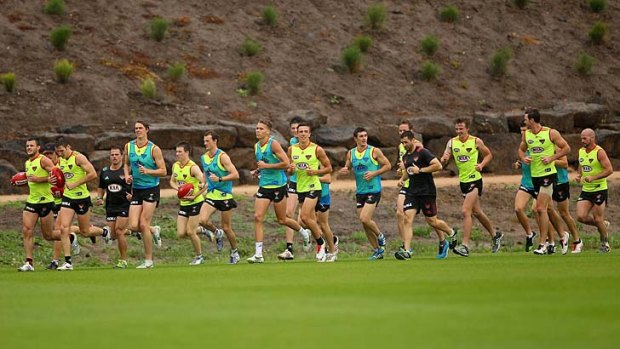 Essendon players train on Wednesday, the day that AFL chief Andrew Demetriou issued a warning to the club.