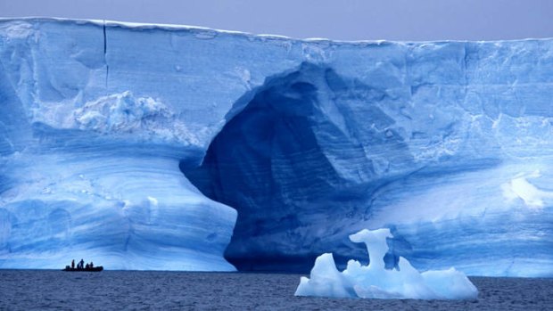 Places to be: Passengers in an inflatable Zodiac are dwarfed by a huge blue iceberg off the coast of the South Shetland Islands to the west of the Antarctic Peninsula.
