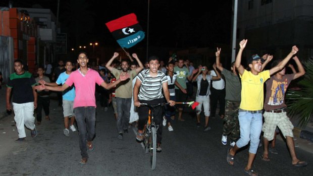 Facing an uncertain future: young supporters of the rebellion against Muammar Gaddafi take to the streets in jubilation in the liberated Tripoli suburb of Tajoura.