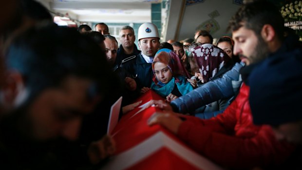 The Turkish flag-draped coffin of Yunus Gormek, who died in the attack.