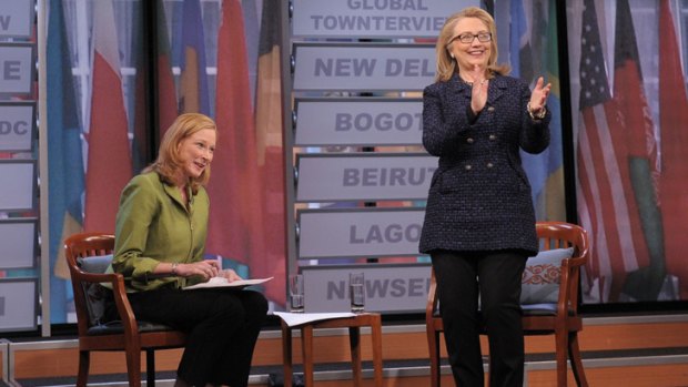 US Secretary of State Hillary Clinton applauds as moderator Leigh Sales watches on.