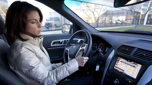 Rebecca Paquette of Nuance Communications' mobile division gives instructions to its voice-activated system in a Ford Explorer.