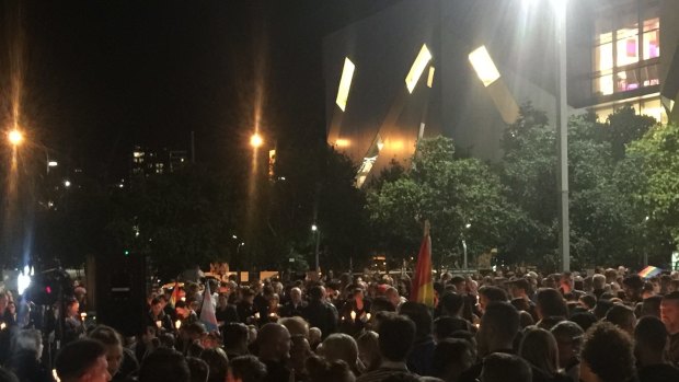 Mourners honour those slain in the Orlando nightclub massacre at a vigil in Brisbane's Reddacliff Place.