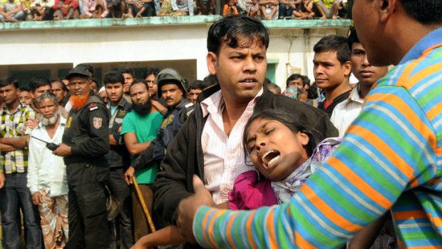 People console a woman whose relative was killed in the fire.