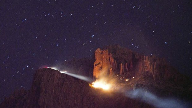 Three children dead ...  a floodlight illuminates a fire from a small plane crash in the Superstition Mountains in Apache Junction, east of Phoenix.